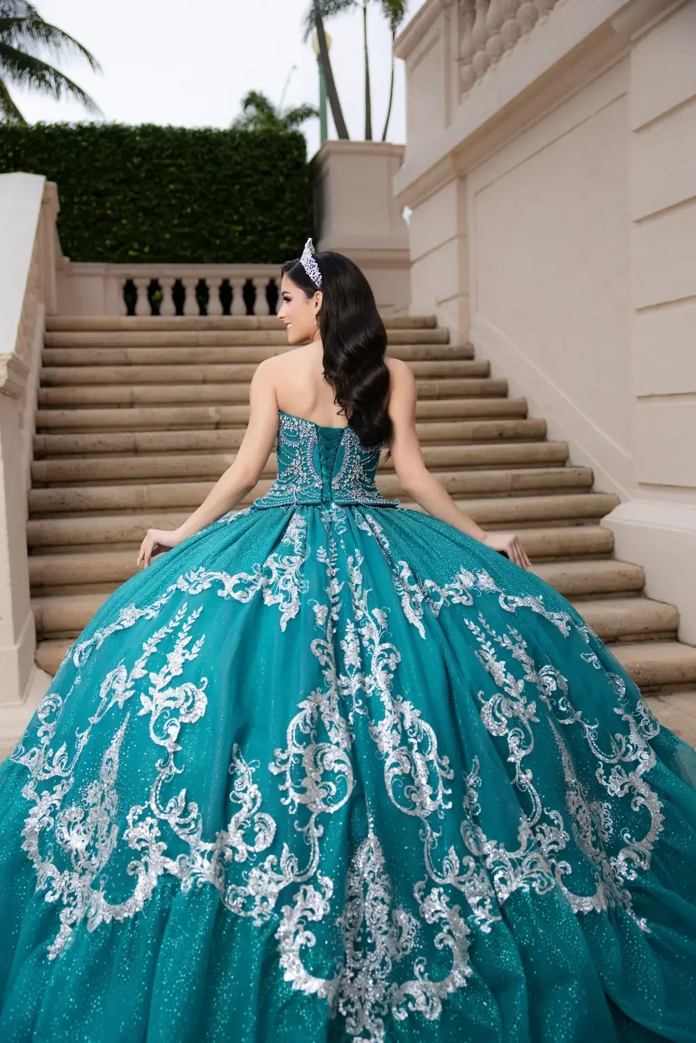 model is wearing a blue quinceanera dress