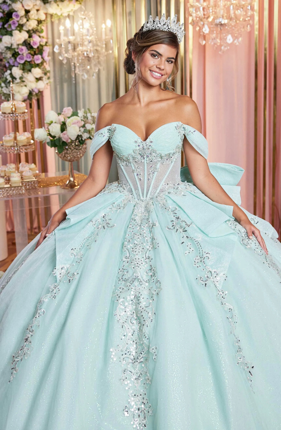 Model is wearing an off the shoulder mint green quince dress with corset boning 