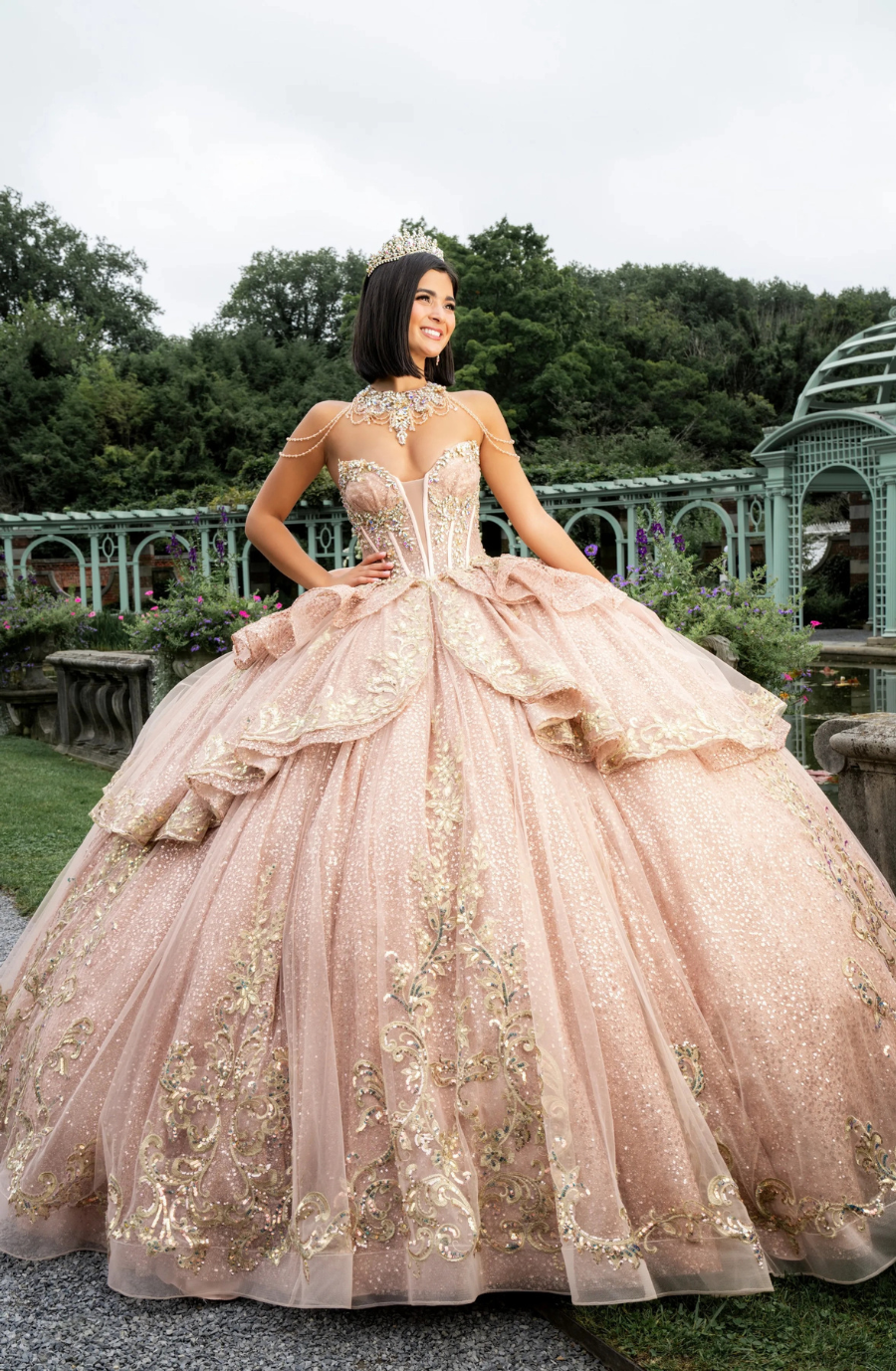Model is wearing a strapless champagne quinceanera dress 