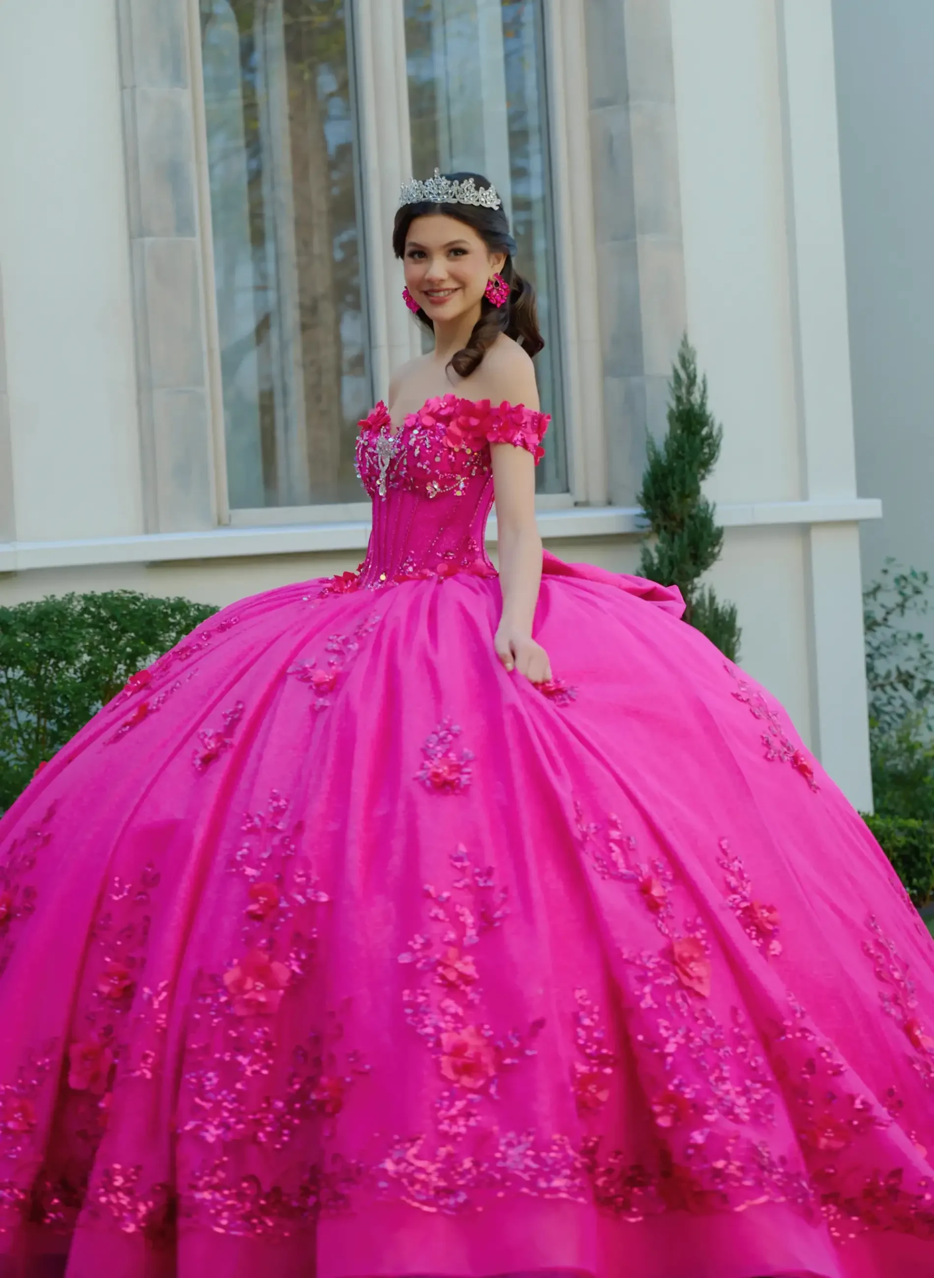 model is wearing a hot pink quince dress